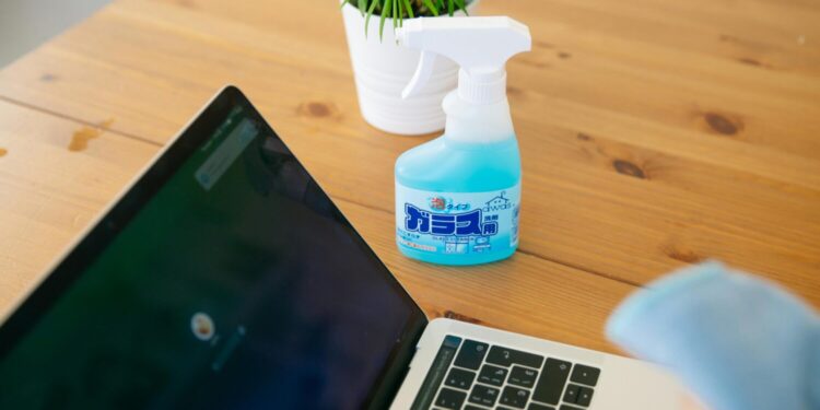 Disinfectant spray near laptop