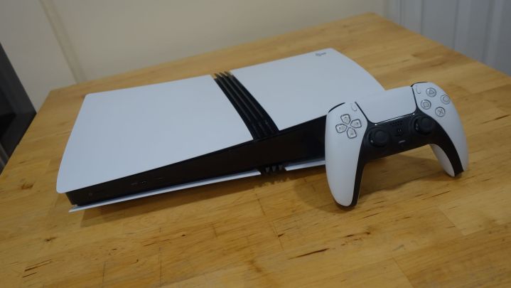 A PS5 Pro is displayed on a table alongside a DualSense controller.