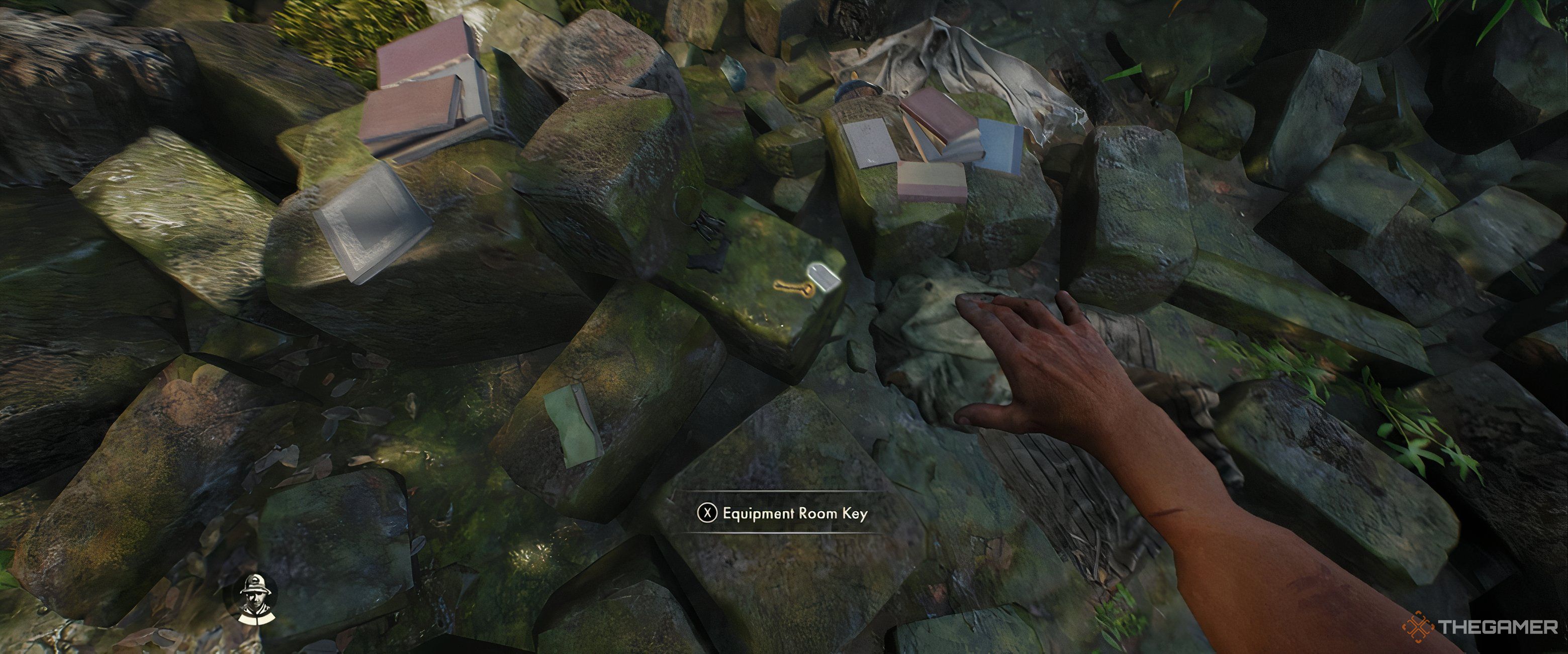 Indy reaching for a key on a rock among various items.