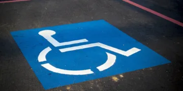 Windows 11 laptop with Start menu showing front hero