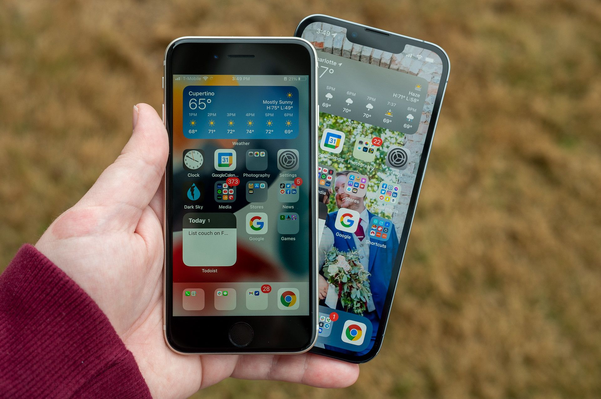 Apple iPhone SE 2022 held next to an iPhone 13 Pro.