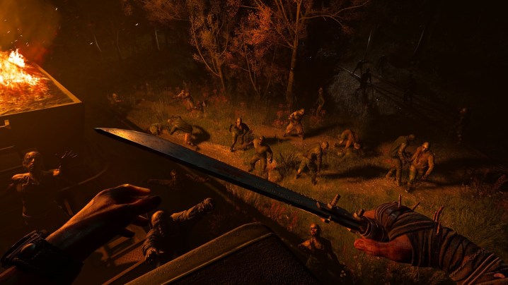 A crowd of zombies illuminated by a fire in Dying Light: The Beast.