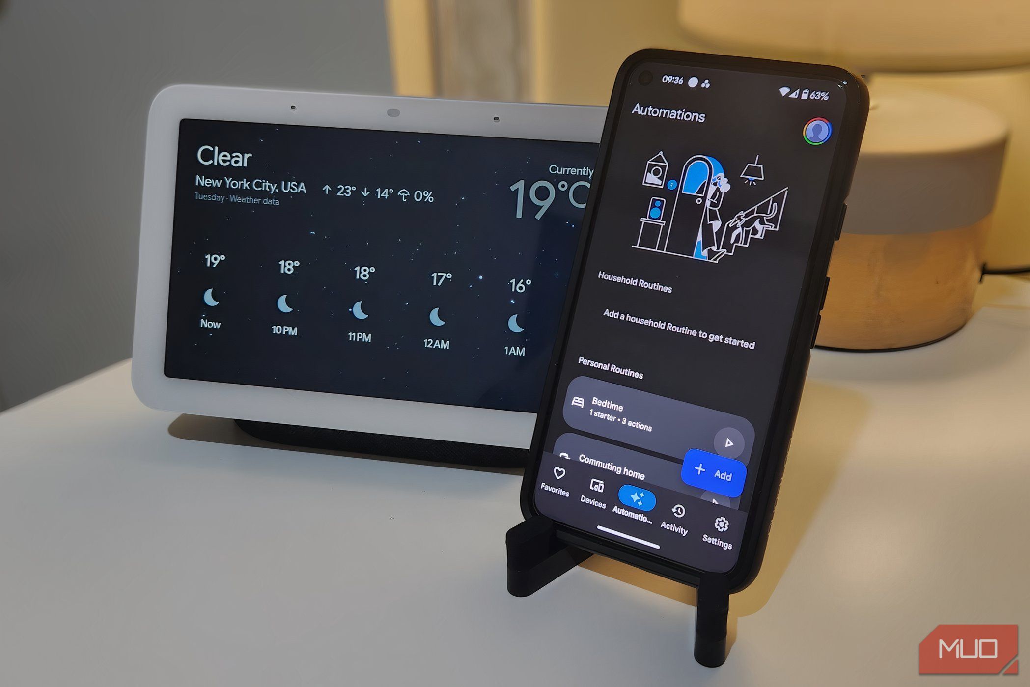 Smartphone displaying the Google Home Automations screen with Nest Hub in the background.