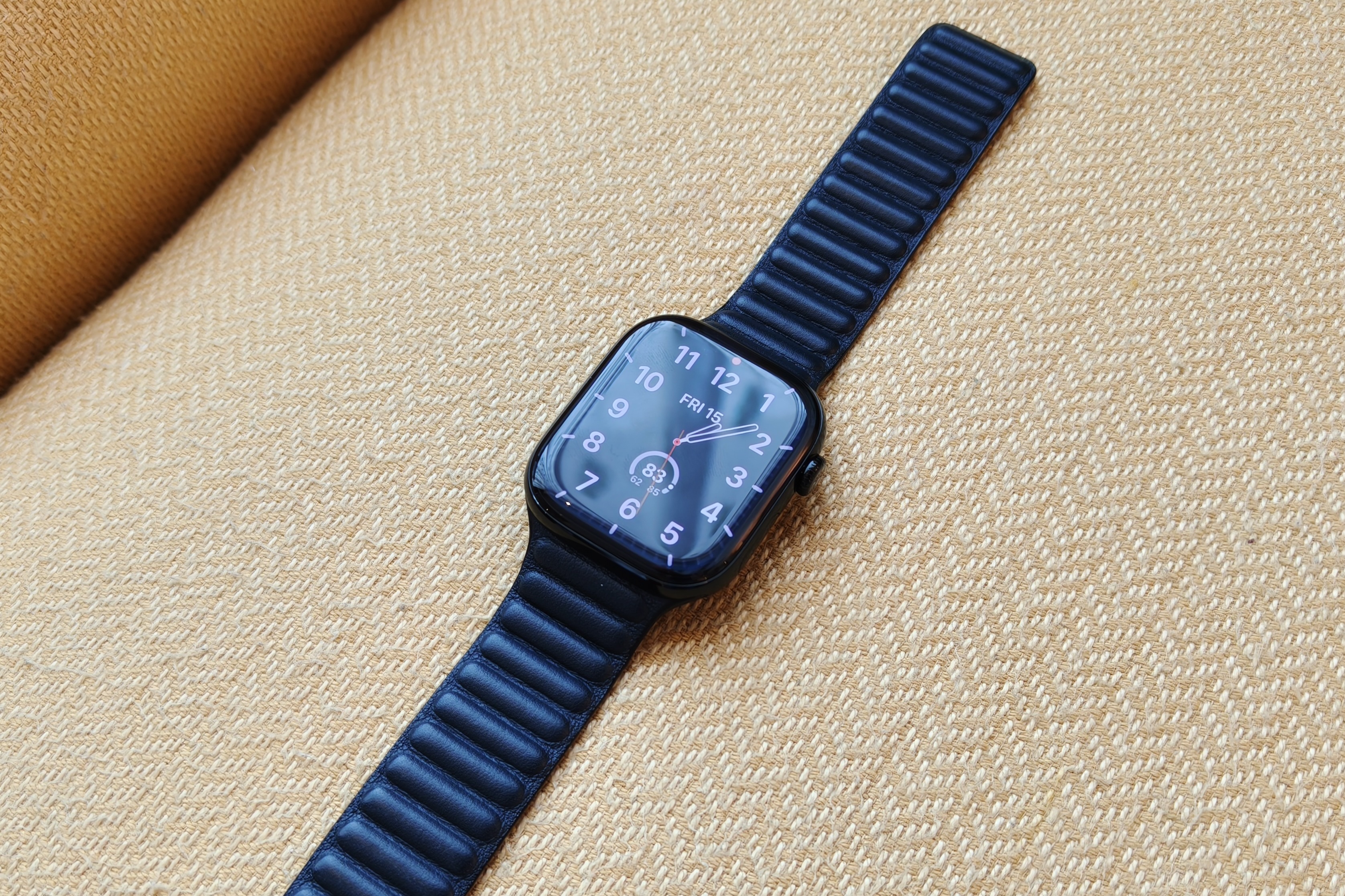 The Apple Watch Series 10 lying on a yellow chair.