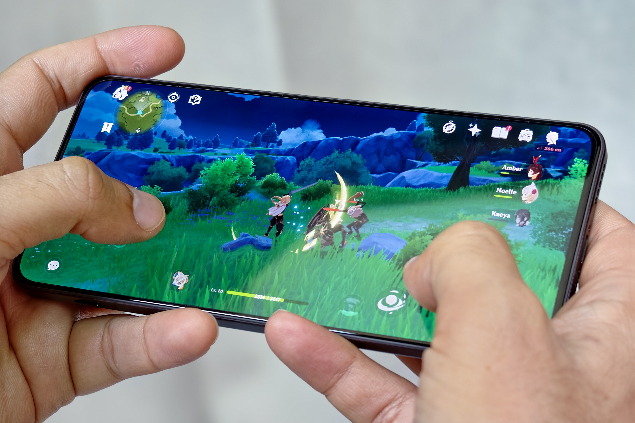 Person playing Genshin Impact on a mobile device