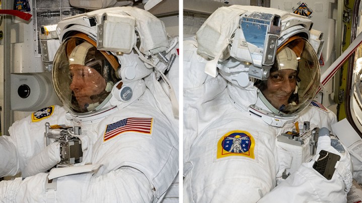 NASA astronauts Nick Hague and Suni Williams examining their spacesuits in a pressurized airlock.