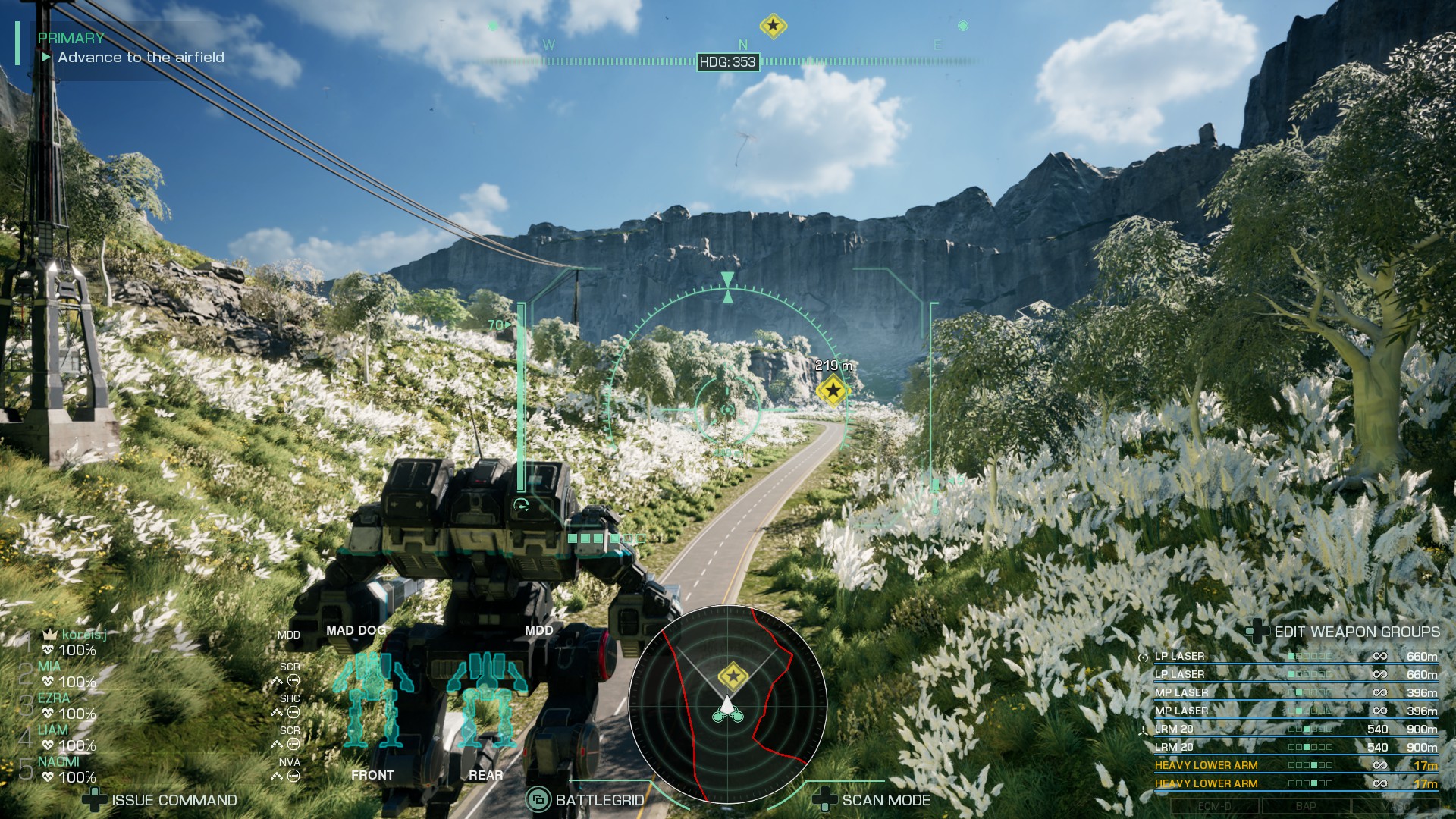 A medium-sized mech travels along a road under blue skies surrounded by flowers in Mechwarrior 5 Clans.