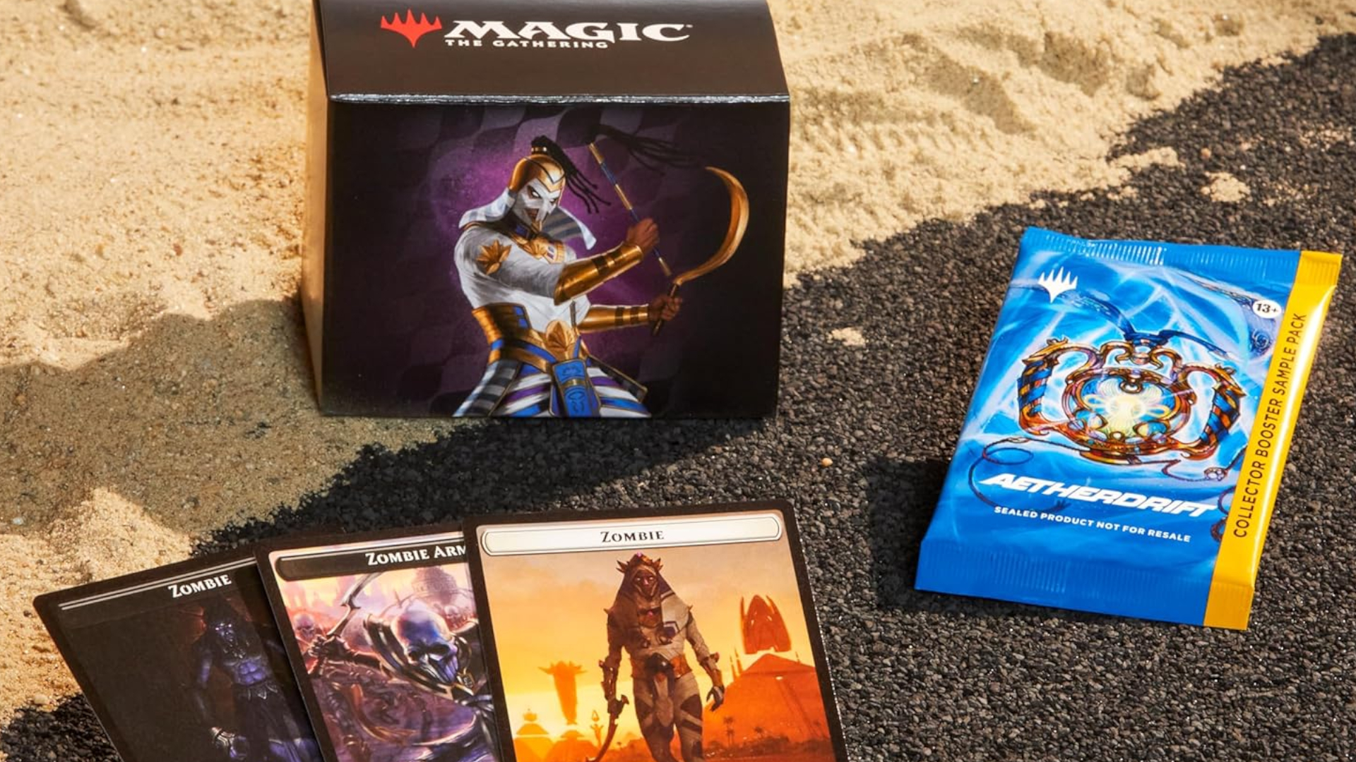 Eternal Might Commander deck on sand, with three token cards and a Collector Booster pack on asphalt
