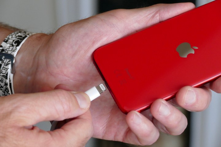 Apple iPhone SE (2020) being charged.