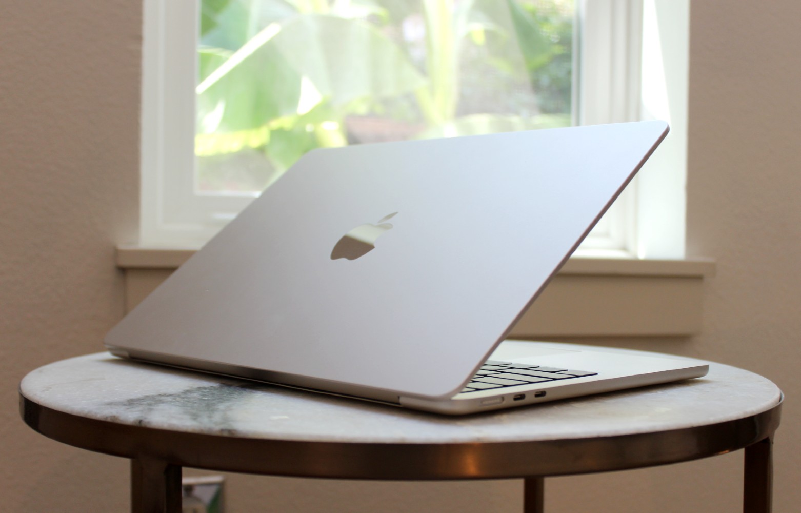 The MacBook Air resting on a table by a window.