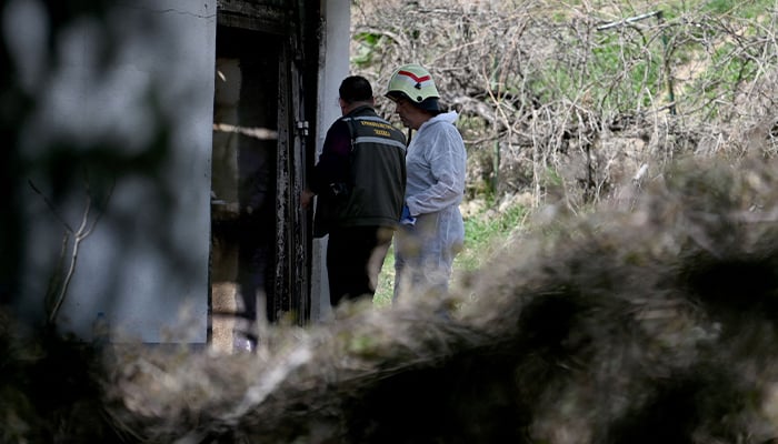 Forensic team entering the nightclub where the fire occurred, March 16, 2025. — AFP