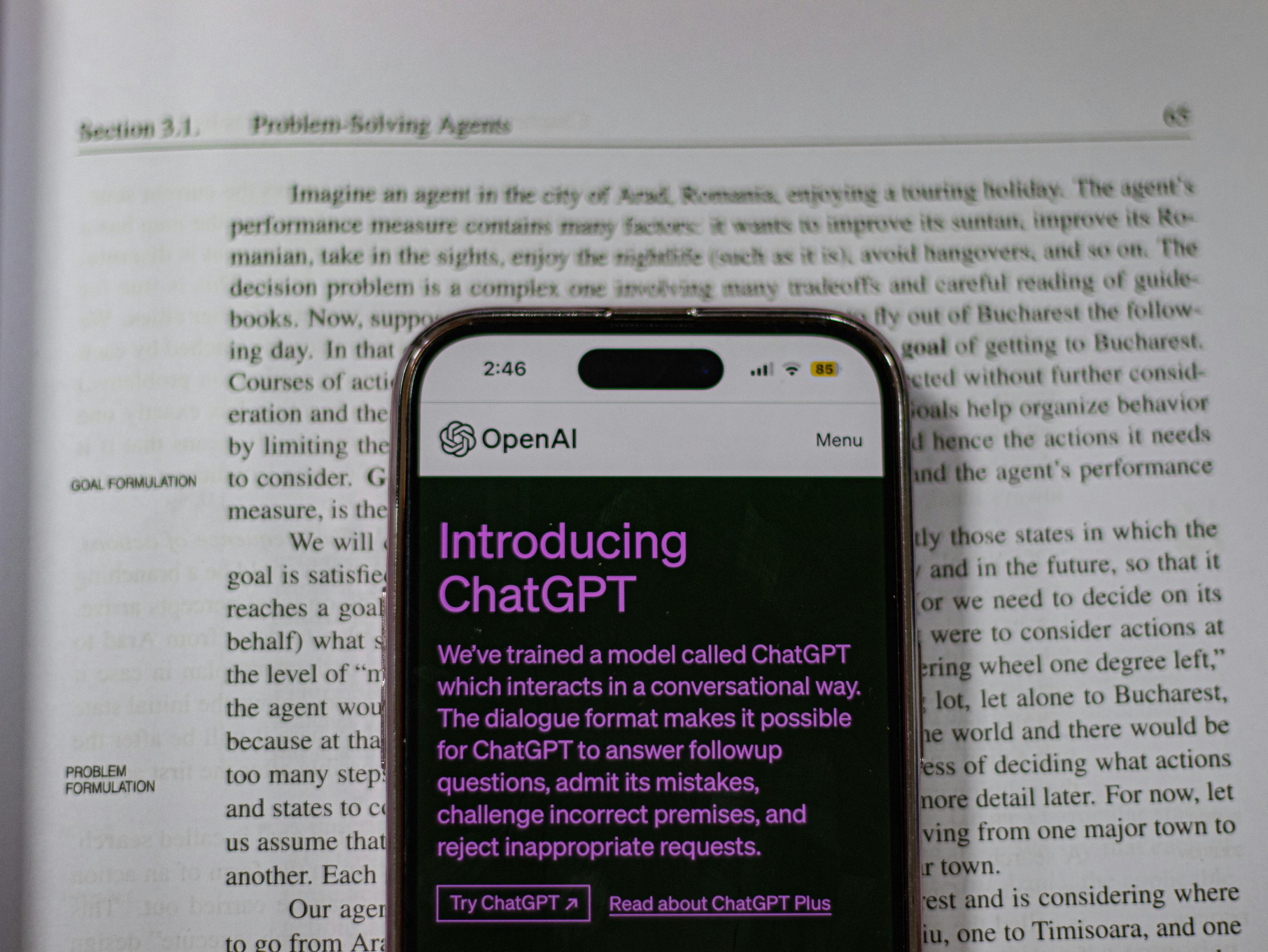 ChatGPT on a phone on an encyclopedia.
