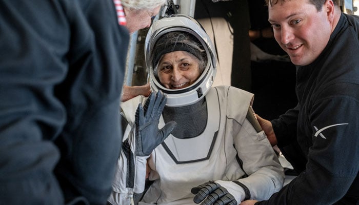 NASA astronaut Suni Williams is assisted out of a SpaceX Dragon spacecraft aboard the recovery ship MEGAN after landing.