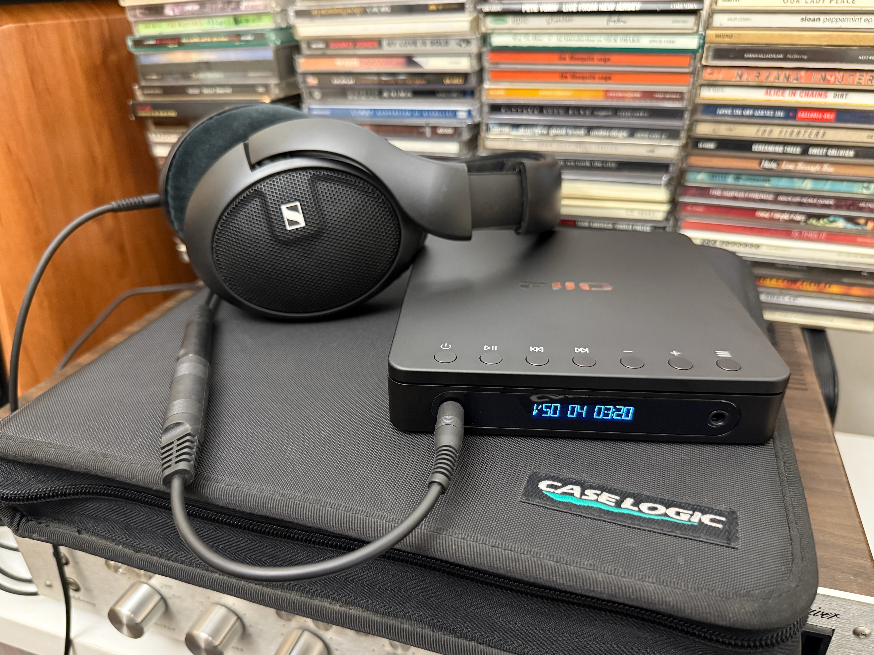 Fiio DM13 Portable Stereo CD player connected to Sennheiser wired headphones.