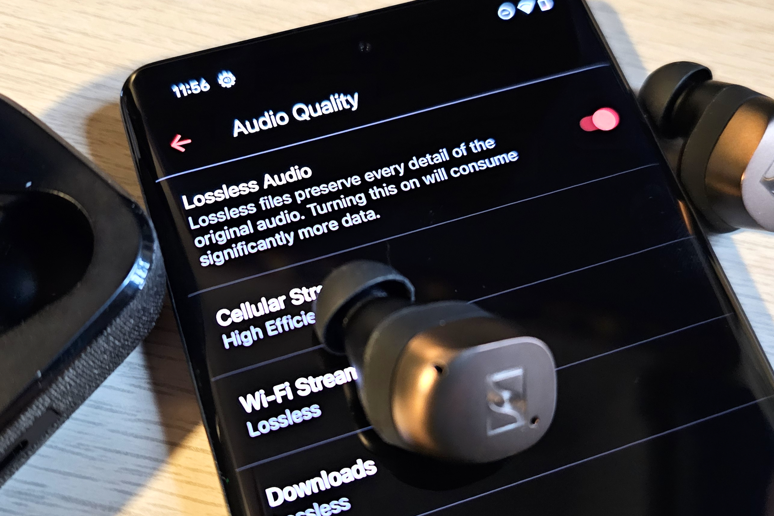 Google Pixel 7 Pro showcasing Apple Music's lossless audio with Sennheiser earbuds.