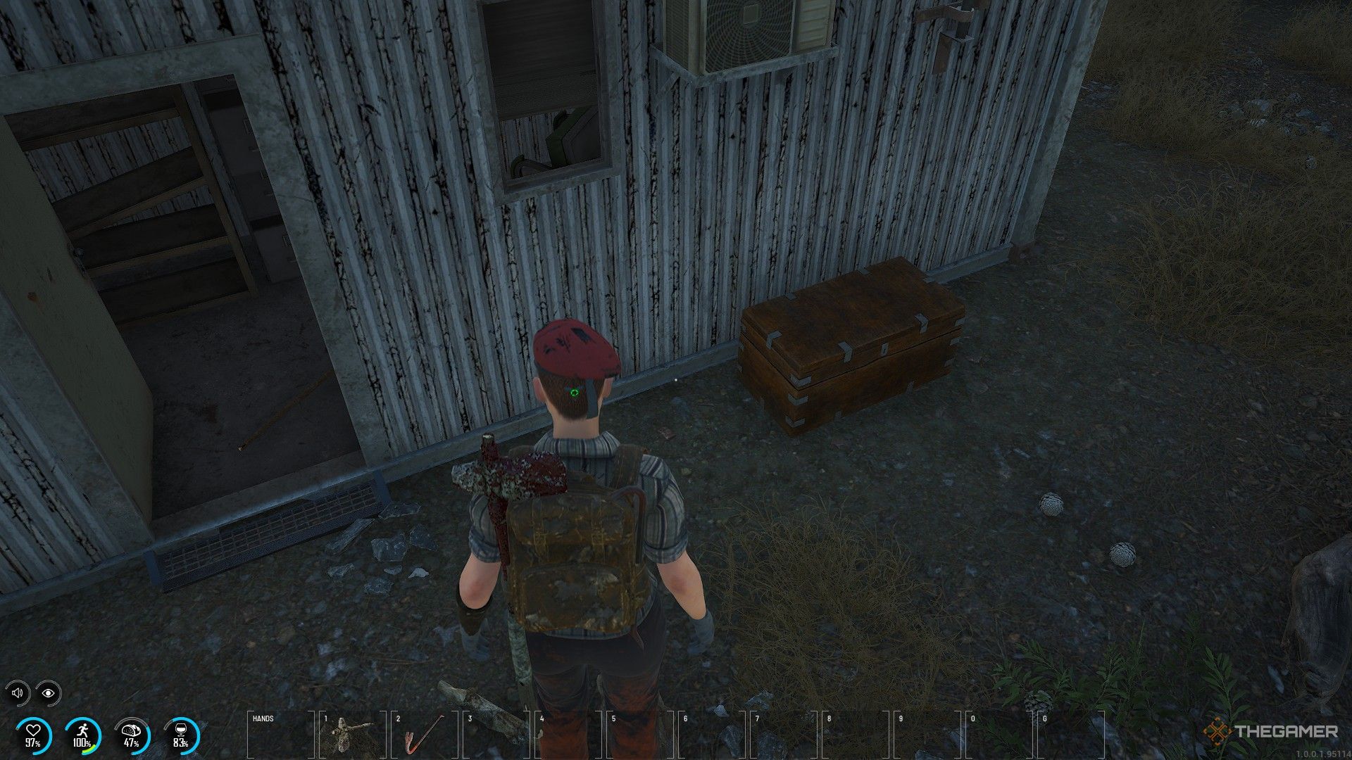 A prisoner in a red beret stands next to a storage chest in Scum.