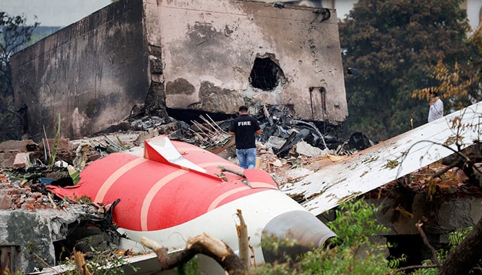 Fire officer stands near the crashed Air India Boeing 787-8 Dreamliner in Ahmedabad, India. — Reuters/File