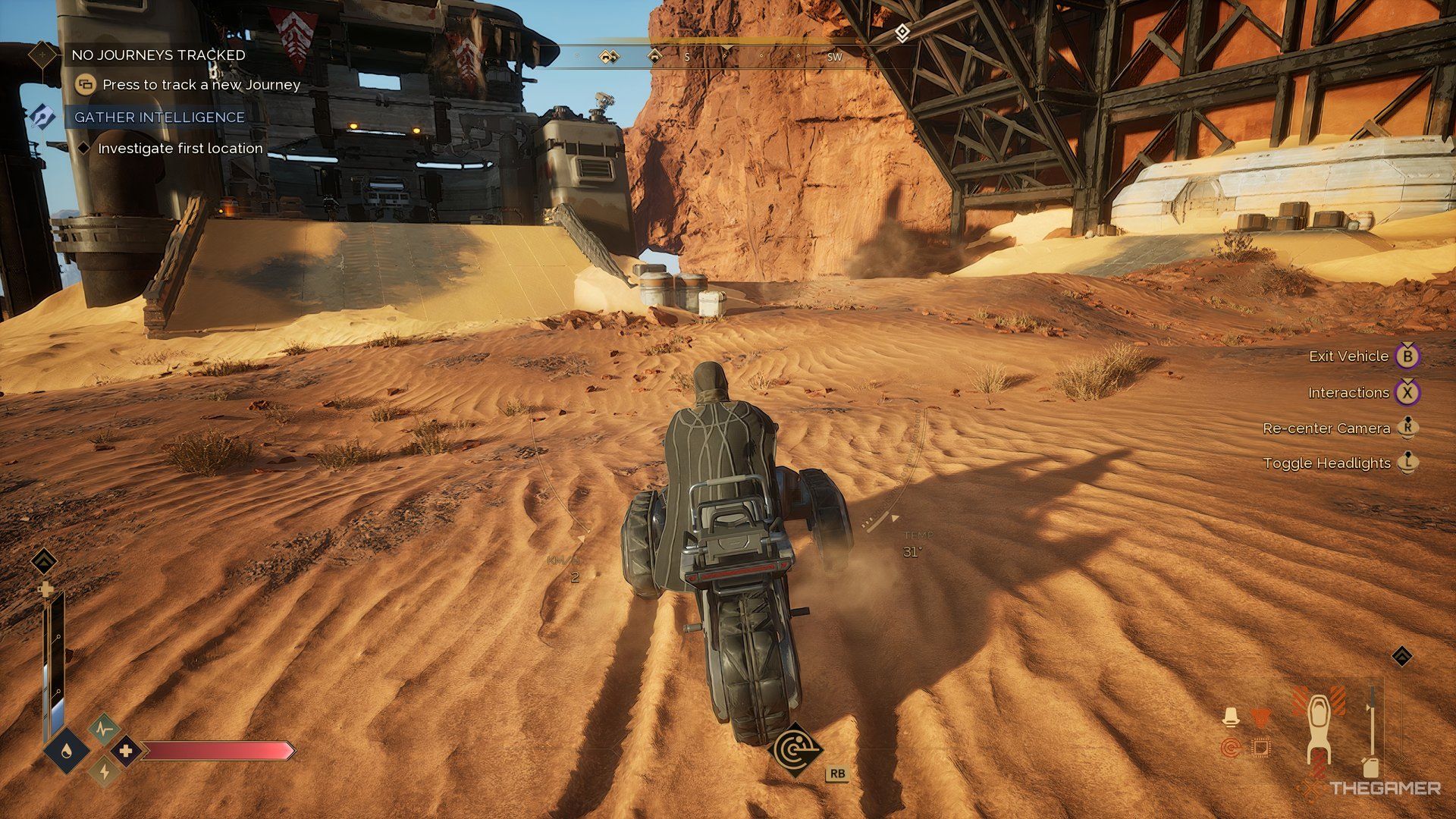 Player on a sandbike in Dune: Awakening near a Buggy in a structure.