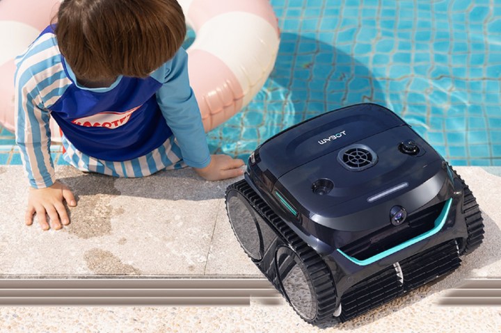 The Wybot C2 Vision robotic pool cleaner beside the swimming pool.