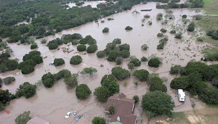 Aerial view of houses and cars partially submerged in floodwaters near Kerrville, Texas, on July 4. — Reuters