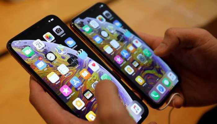 A person holding smartphones.