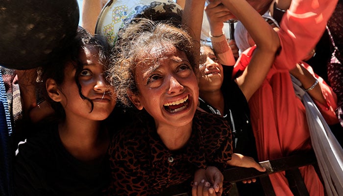 Palestinians waiting for food at a charity kitchen amid hunger crisis in Khan Younis, south Gaza, August 4, 2025. — Reuters