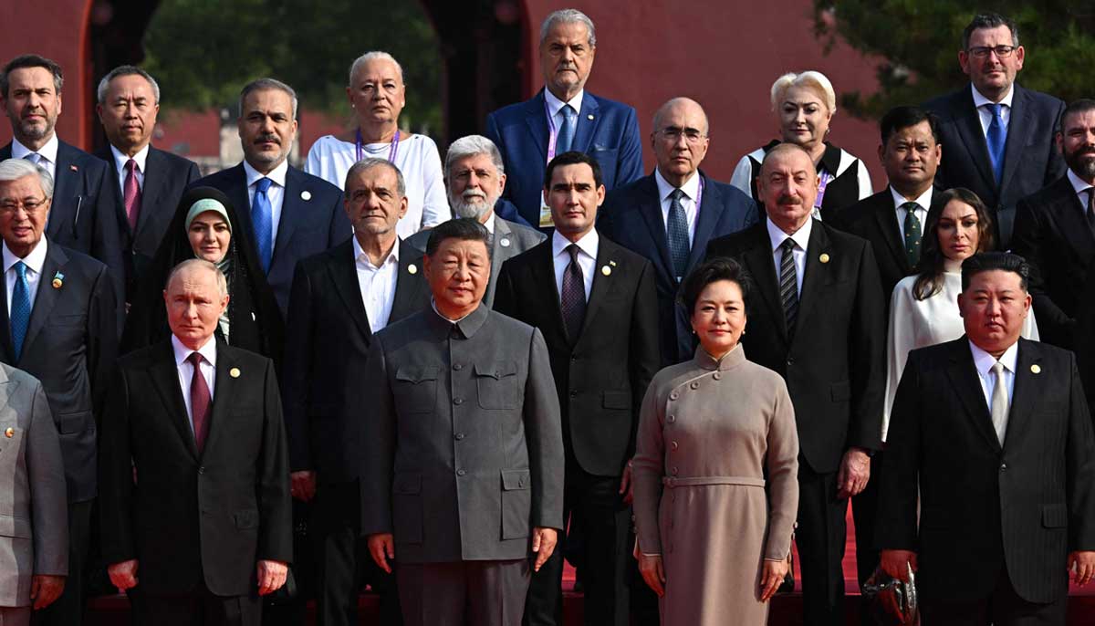 Xi Jinping and Vladimir Putin pose for a group photo along with other international dignitaries at the Beijing military parade — AFP