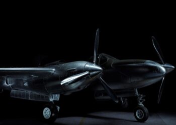 Chrome logo on laptop screen over the shoulder as woman types