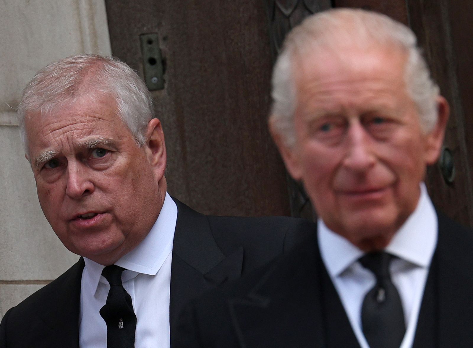 Prince Andrew, Duke of York, and King Charles III leave following a Requiem Mass
