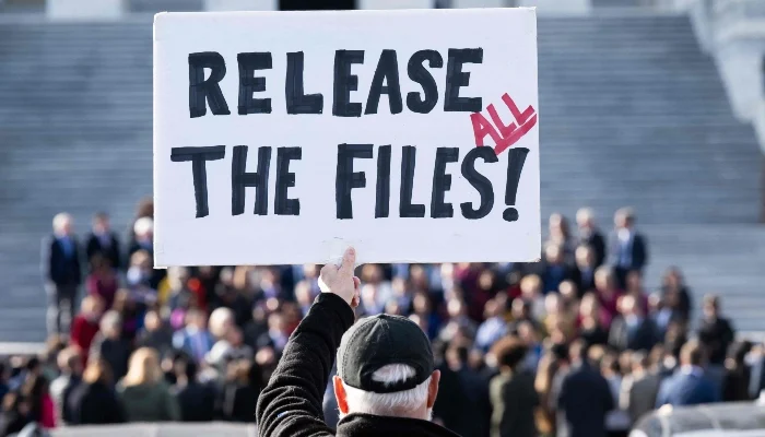 Protester holding a sign demanding the release of Epstein case files outside the U.S. Capitol on November 12, 2025. — AFP