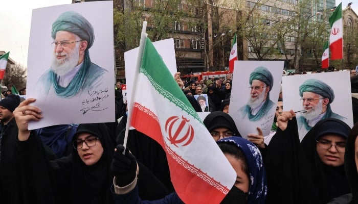 Iranian women hold portraits of Iran’s Supreme Leader Ayatollah Ali Khamenei during the funerals of security forces personnel in Tehran, January 14, 2026. — AFP