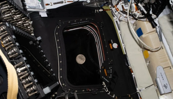 This handout picture by an Artemis II crew member provided by Nasa shows the moon through a window of the Orion spacecraft on April 6, 2026. — AFP